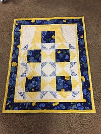 Lap quilt with hand warmer pocket